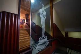 Chaturvedi, Hemant (Photographer). The famous Oscar trophy etched on a mirror panel leading up to the balcony of Regal Cinema, Mumbai, India, c. 2019-2024 | Contemporary Photograph