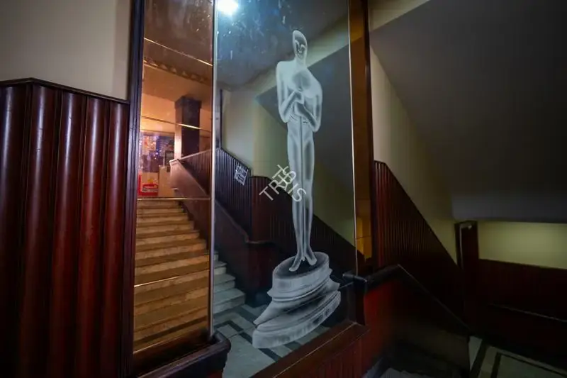 Hemant Chaturvedi (Photographer), The famous Oscar trophy etched on a mirror panel leading up to the balcony of Regal Cinema, Mumbai, India, 2024, Contemporary Photograph