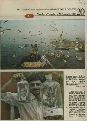 A man feeds birds at Sangam, 2008, Newspaper Clipping