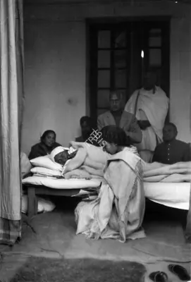 Henri Cartier-Bresson (Photographer), Gandhiji lying on his bed on the fifth day of his fast as Dr.Sushila Nayar reads him a letter Birla House 17 January 1948, 1948, Contemporary Photograph