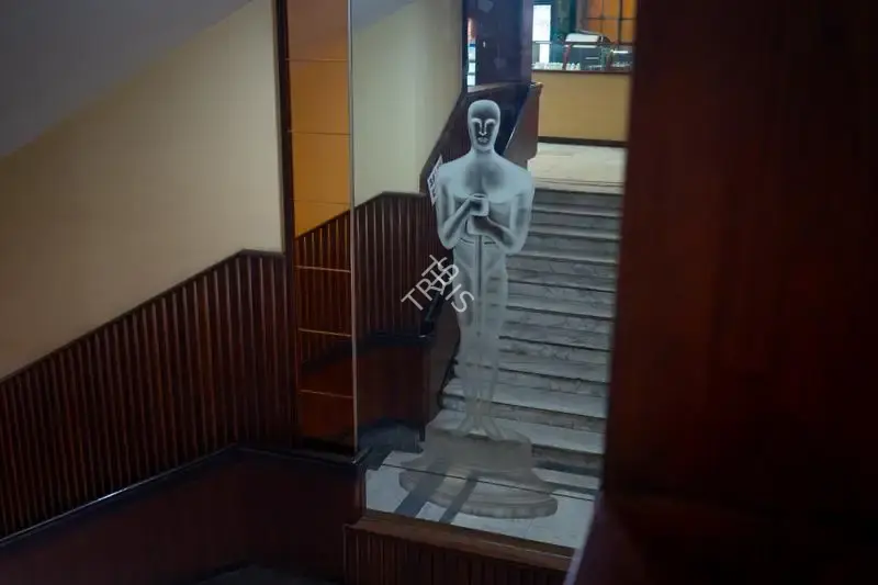 Hemant Chaturvedi (Photographer), The famous Oscar trophy etched on a mirror panel leading up to the balcony of Regal Cinema, Mumbai, India, 2024, Contemporary Photograph