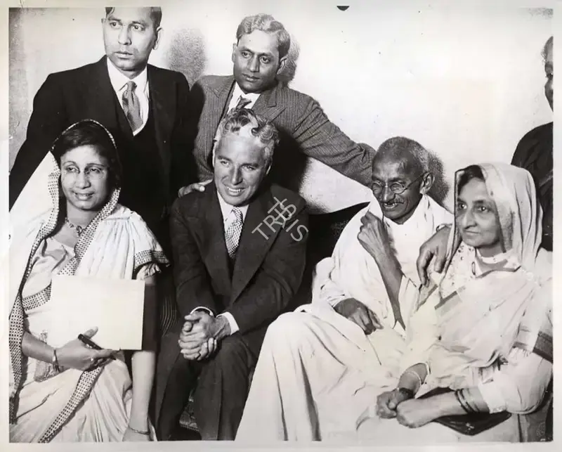 Unknown (Photographer). Charlie Chaplin and Mahatma Gandhi - This photograph shows Chaplin and Gandhi  together at Dr. Katial's residence. Renowned Indian artist Somnath Khosa turned this phtoograph into a painting, 22 September 1931 | Photographic Still | CinemaEducation | 00440369
