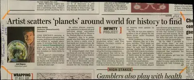 Adam Gorlick (Reporter), Artist Scatters 'Planets' around World for History to Find, 2006, Newspaper Clipping