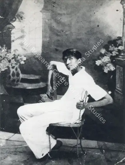 (Photographer). Husain as a teenager, photographed against a backdrop he painted. Photographic Still, 1934 | Contemporary Photograph, Maqbool Fida Husain, 1971 | Photography | 00501645