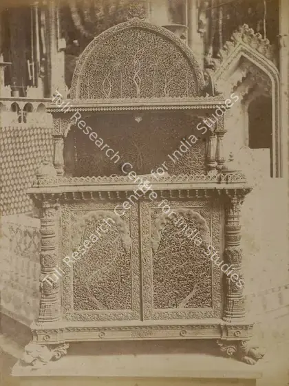 Narayan, Shew Shankar (Photographer). Ahmedabad Cabinet in carved Wood with Designs copied from Ancient Mosques - Bombay Court, Front View - From the album 'Calcutta International 1883-84 Exhibition Views'. Albumen print pasted on mount, 1883-1884 | Antiquarian Photograph | Photography | 00115293