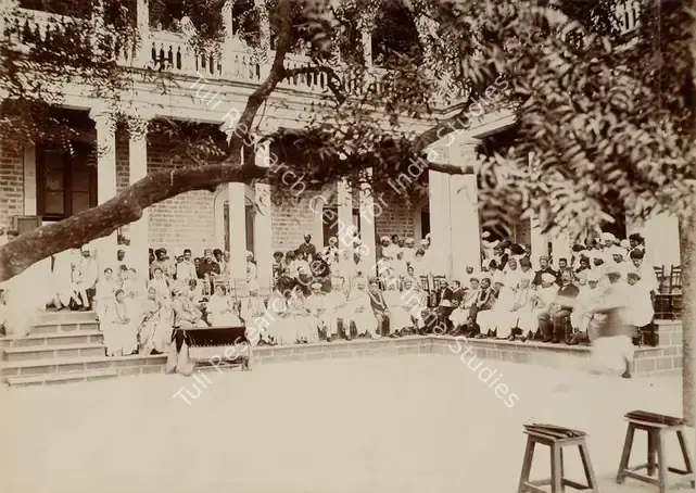 Studio Bourne & Shepherd (Photographic Studio). Prize Distribution at the Monghiba High School for Girls. His Highness the Maharaja Saheb of Bhavnagar presiding - From the album 'Shri Bhagvatsinhji Silver Jubilee Memorial Album. Gondal A.D. 1909 by Bourne & Shepherd'. Silver gelatin print pasted on mount, 1909 | Antiquarian Photograph | Photography | 00115355