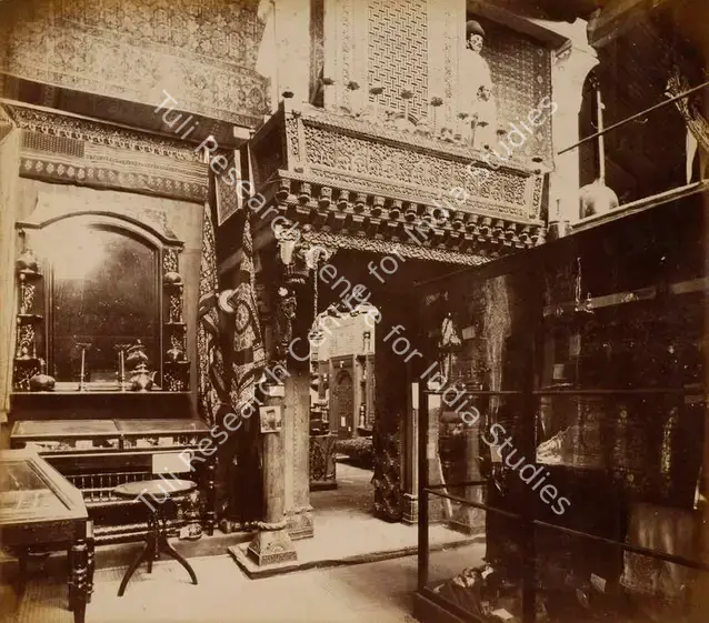Narayan, Shew Shankar (Photographer). The Baroda Wooden Gateway and Figures and the Nasic Window and Brass Work - Bombay Court - From the album 'Calcutta International 1883-84 Exhibition Views'. Albumen print pasted on mount, 1883-1884 | Antiquarian Photograph | Photography | 00115289