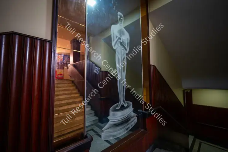 Chaturvedi, Hemant (Photographer). The famous Oscar trophy etched on a mirror panel leading up to the balcony of Regal Cinema, Mumbai, India. c. 2019-2024 | Contemporary Photograph | Photography | 00840062